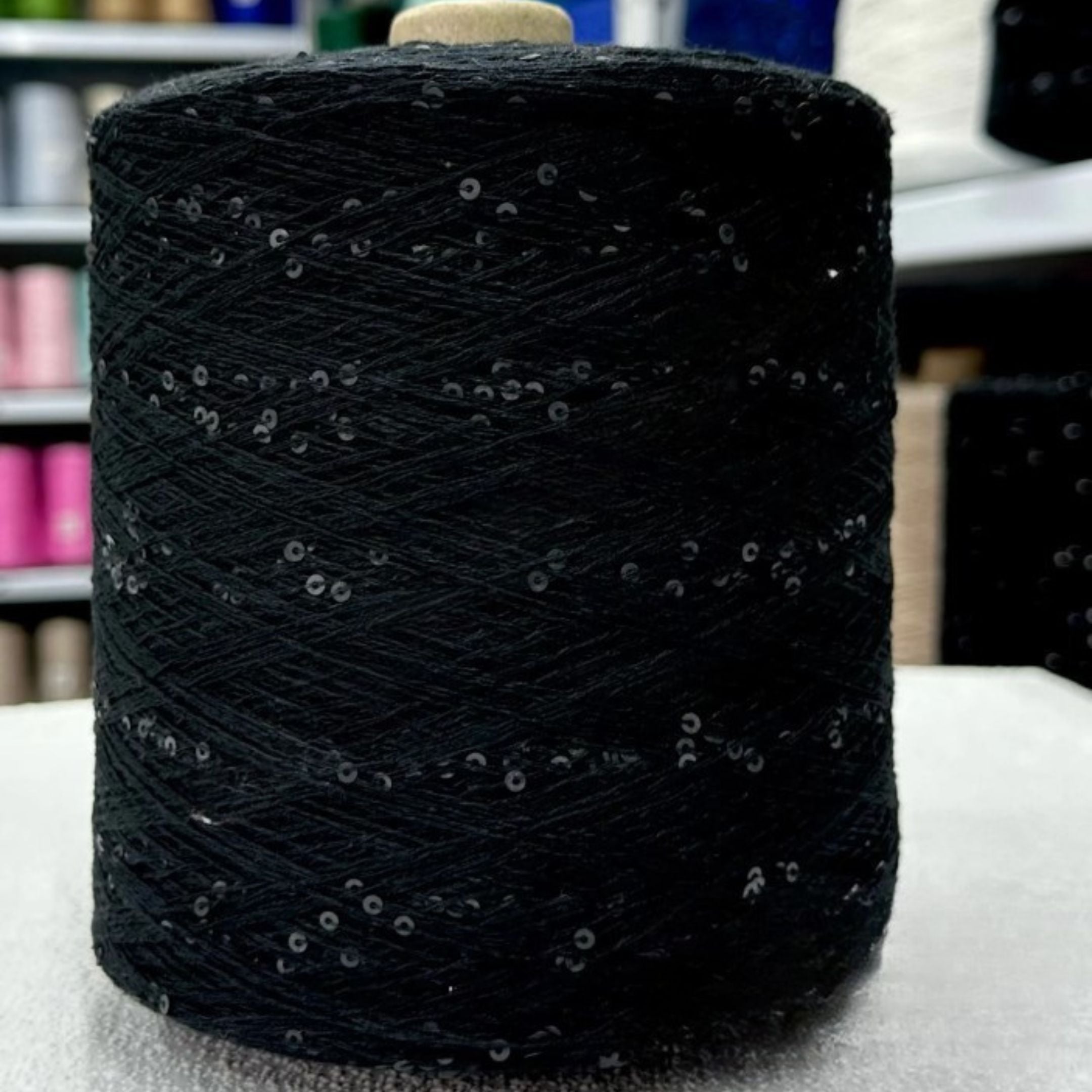 Gentle hand holding soft sparkling sequin yarn