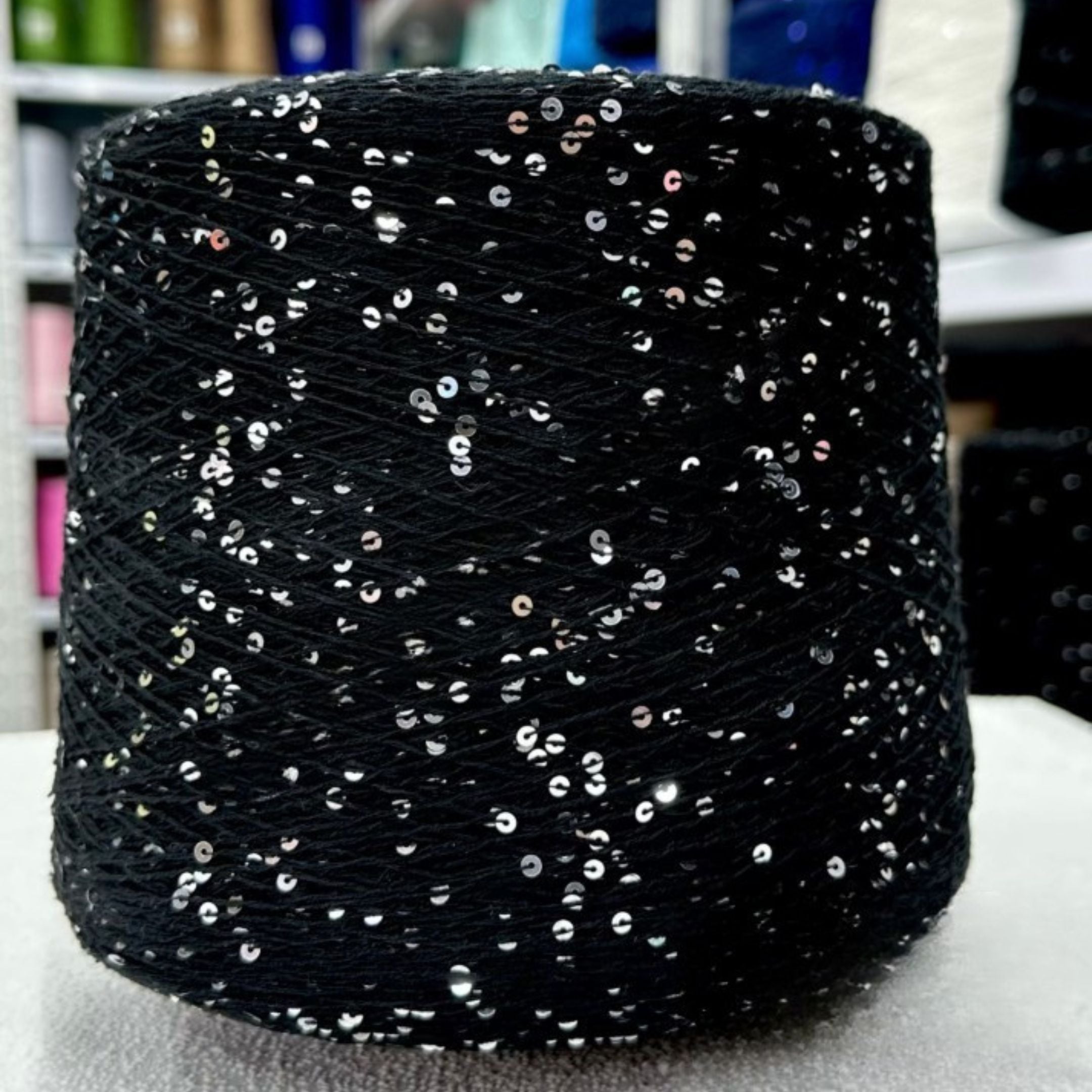 Sparkling yarn ball next to crochet hook