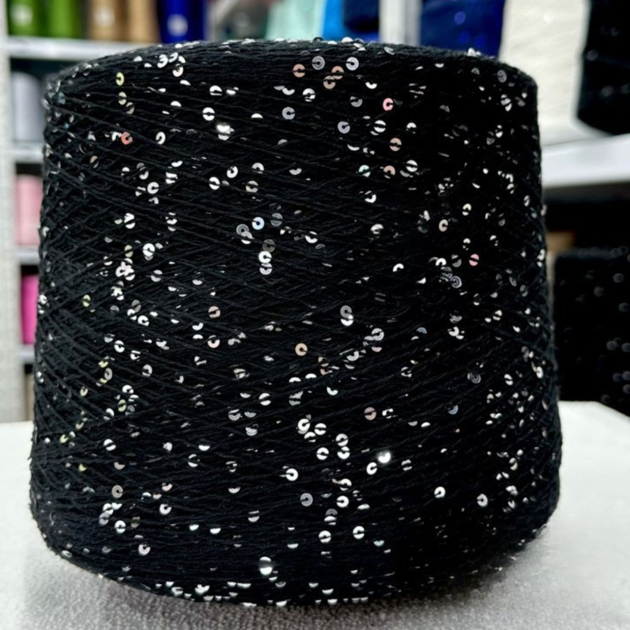 Sparkling yarn ball next to crochet hook