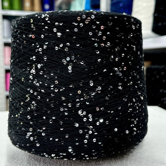 Sparkling yarn ball next to crochet hook