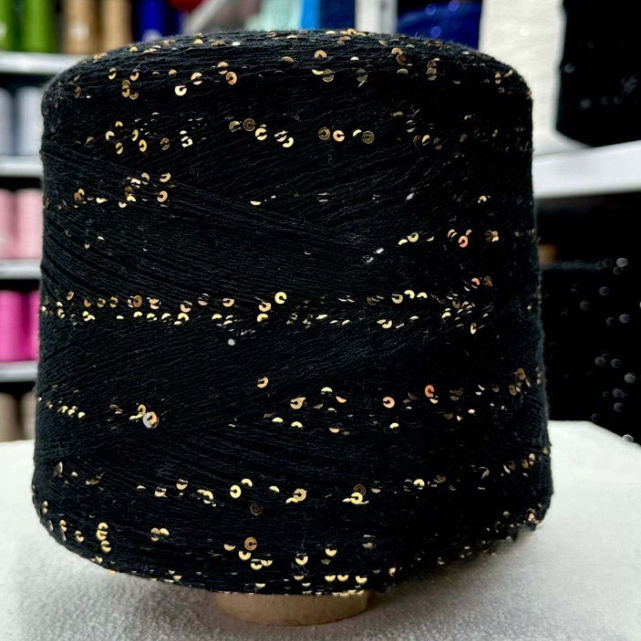 Macro shot of shimmering 3mm sequins on soft cotton