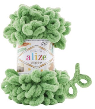 Green yarn with a can of Alize yarn in the background