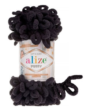 Alize puffy black  yarn with black pom-pom-like texture on a white background