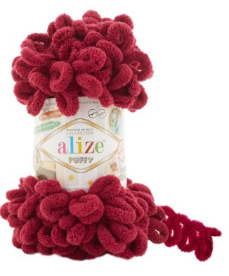 Red floral arrangement on top of a glass jar with 'alize' branding.