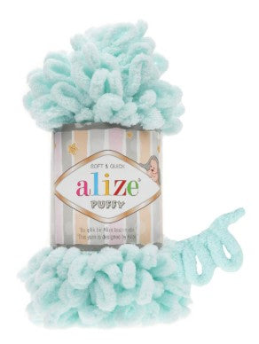 Alize fluffy yarn with packaging on a white background
