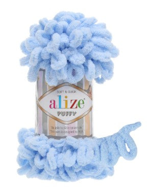 Blue yarn ball with a visible brand label on a white background