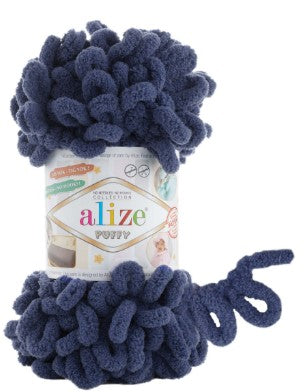 Blue fuzzy yarn ball on an Alize Puffy 215 yarn package