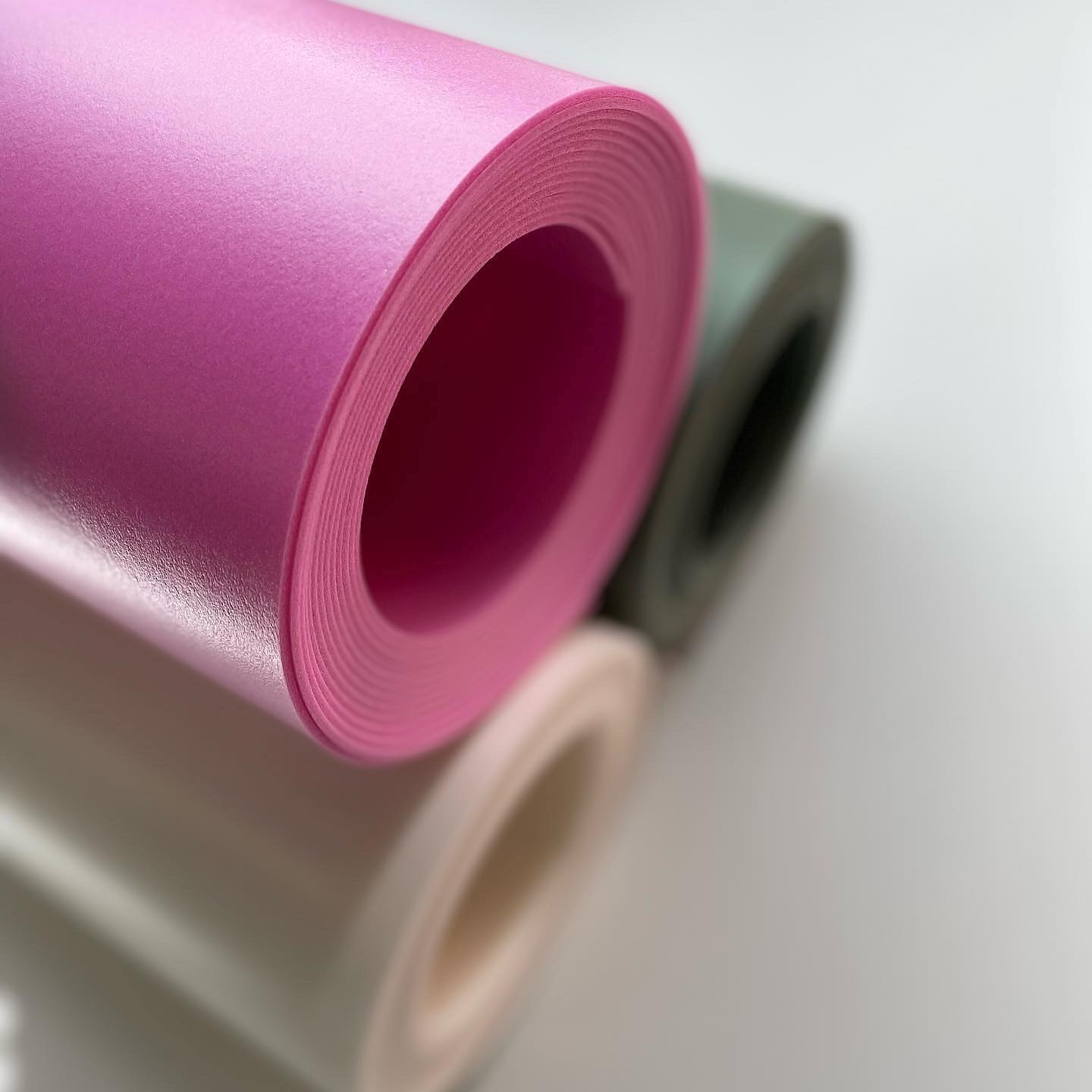 Roll of pink paper on a white background