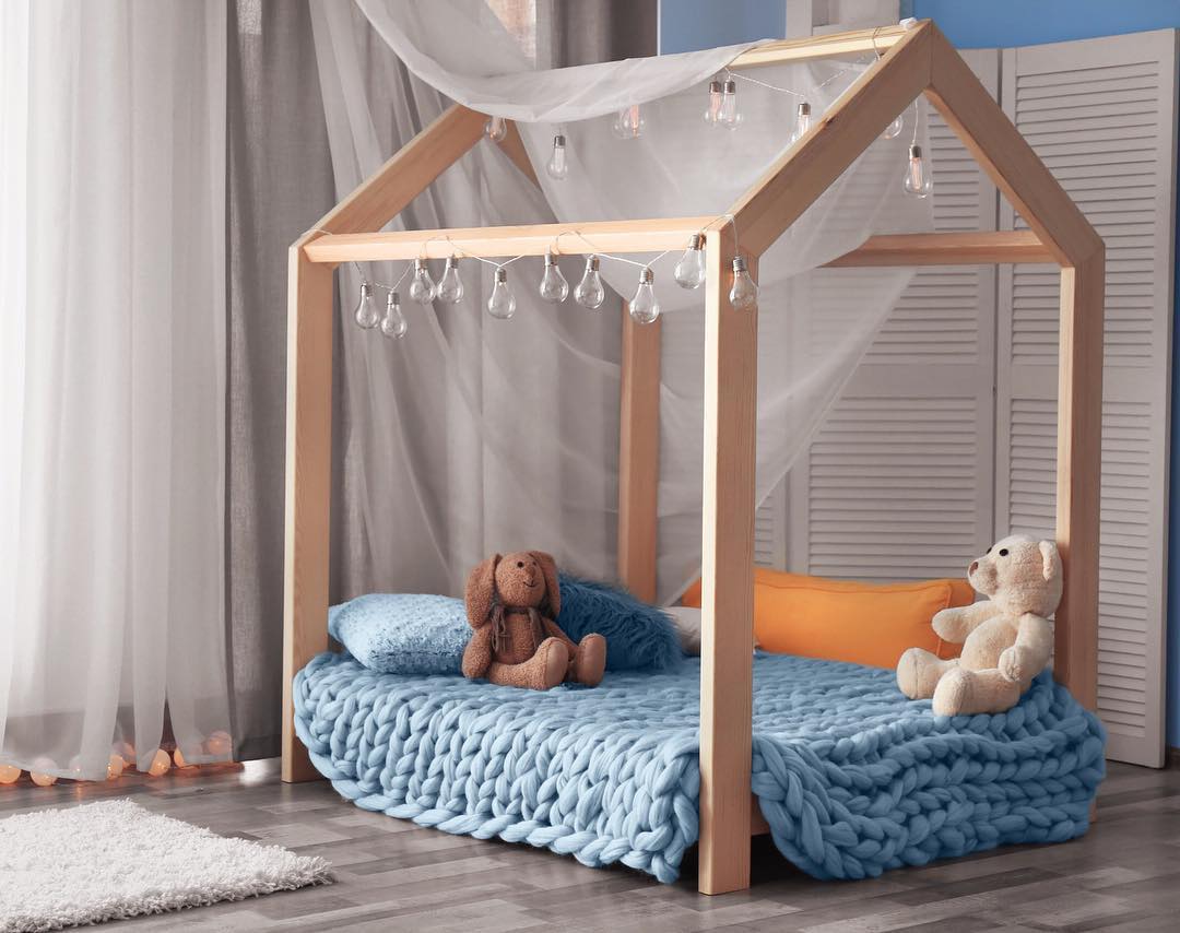 Gray super bulky arm-knit blanket on sofa