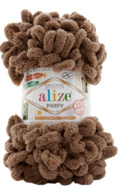 Ball of brown yarn with Alize Puffy 466 label on a white background