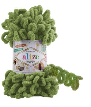 Green yarn with a visible brand label on a white background