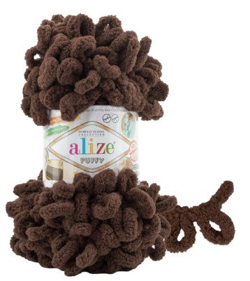 Brown yarn ball with a visible 'alize puffy 493' label on a white background