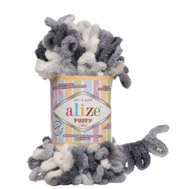 Gray and white yarn ball on top of an Alize yarn container with a white background