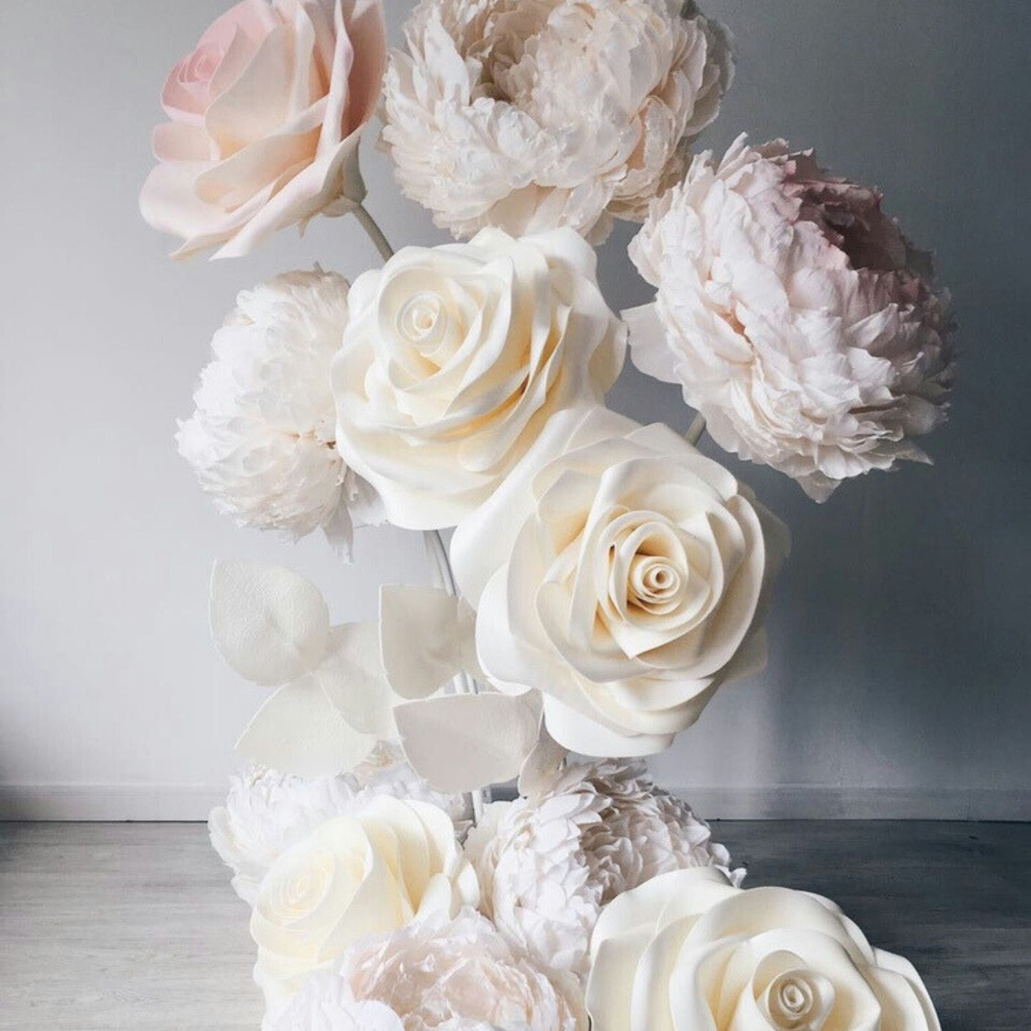 Handmade giant peony composition with roses and foliage base, ivory pastel palette, stunning wedding decor piece