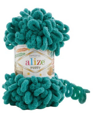 Teal yarn with pom-pom texture around a cylindrical container labeled 'alize'.