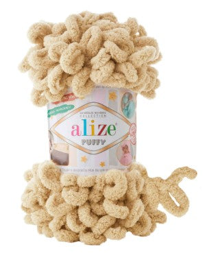 Ball of beige yarn with 'alize' label on a white background