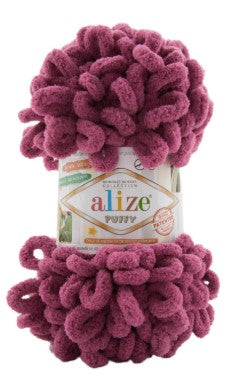 Ball of pink yarn with 'alize' label on a white background