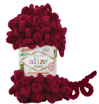 Red yarn ball with 'Alize' label on a white background