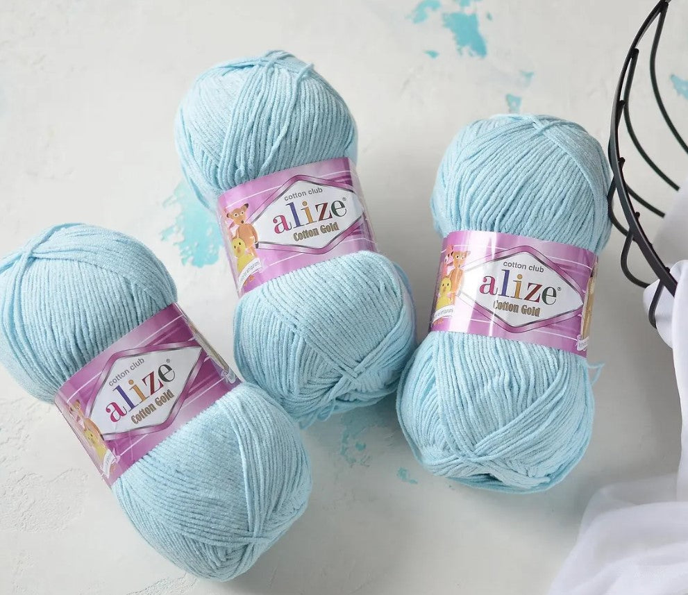 Ball of Alize Cotton Gold in elegant beige or pearl tone (color 592 or similar), smooth matte finish, 330 meters per 100g skein, perfect for spring/summer knitting and crochet garments