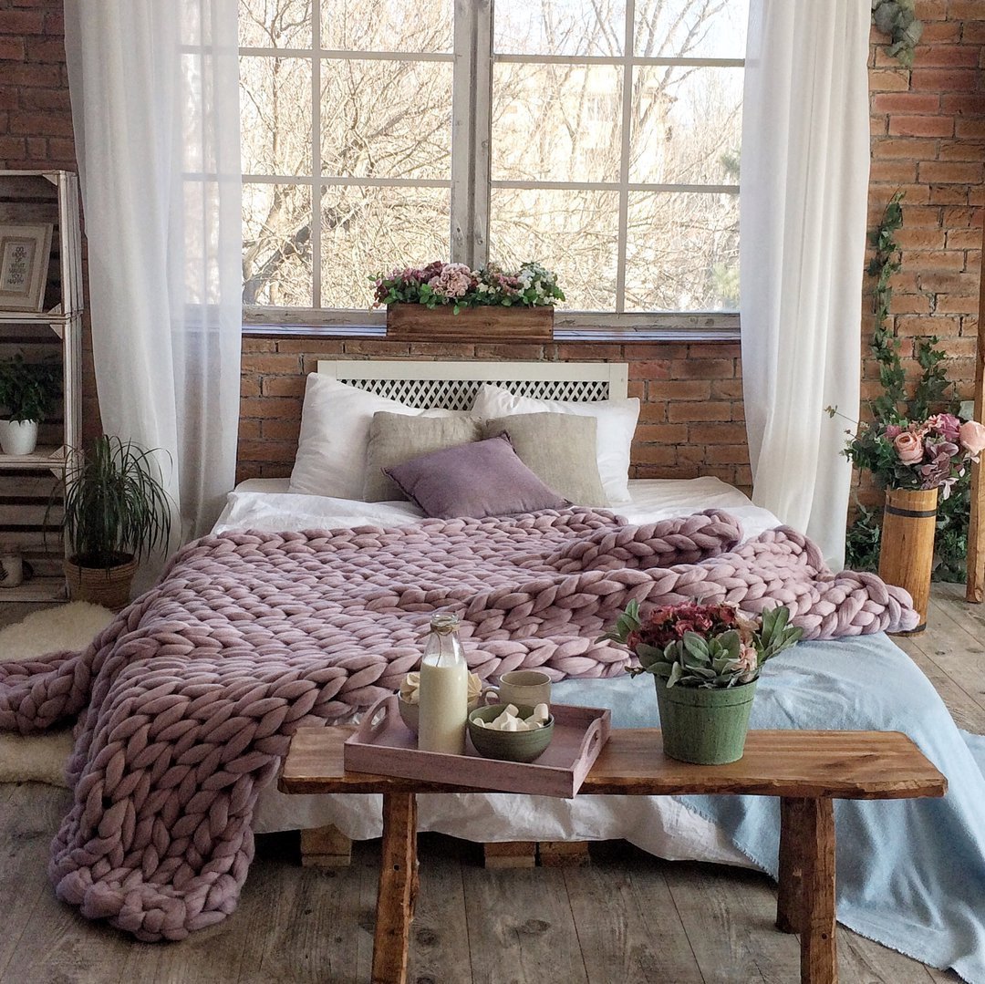 Bordeaux 60x80 blanket casually tossed on velvet ottoman